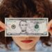 close up shot of a person holding paper money