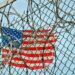 american flag on pole under blue sky during daytime